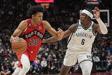 Nov 23, 2022; Toronto, Ontario, CAN; Toronto Raptors guard Jeff Dowtin (20) drives to the net against Brooklyn Nets forward David Duke Jr. (6) during the second half at Scotiabank Arena. Mandatory Credit: John E. Sokolowski-USA TODAY Sports