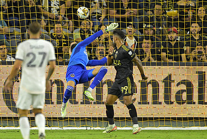 Sep 16, 2023; Los Angeles, California, USA;  Los Angeles FC forward Denis Bouanga (99) scores a goal past Los Angeles Galaxy goalkeeper Jonathan Bond (1) off a pass by Los Angeles Galaxy forward Michael Barrios (12) in the first half at BMO Stadium. Mandatory Credit: Jayne Kamin-Oncea-USA TODAY Sports