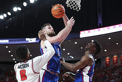Mar 9, 2024; Houston, Texas, USA; Kansas Jayhawks center Hunter Dickinson (1) attempts to score as Houston Cougars guard Mylik Wilson (8) defends during the first half at Fertitta Center. Mandatory Credit: Troy Taormina-USA TODAY Sports