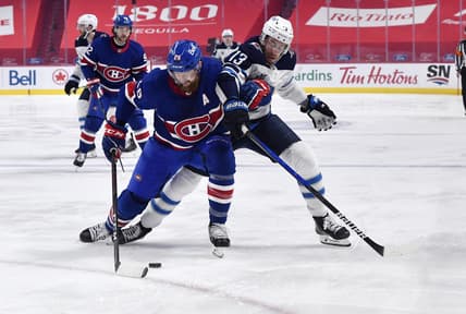Apr 10, 2021; Montreal, Quebec, CAN; Montreal Canadiens defenseman Jeff Petry (26) plays the puck against Winnipeg Jets forward Pierre-Luc Dubois (13) during the first period at the Bell Centre. Mandatory Credit: Eric Bolte-USA TODAY Sports