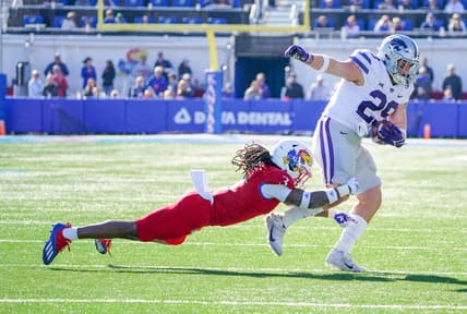 Nov 6, 2021; Lawrence, Kansas, USA; Kansas State Wildcats fullback Jax Dineen (29) runs the ball and is tackled by Kansas Jayhawks safety Ricky Thomas Jr. (3) during the first half at David Booth Kansas Memorial Stadium. Mandatory Credit: Denny Medley-USA TODAY Sports