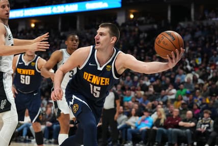 Apr 5, 2022; Denver, Colorado, USA; Denver Nuggets center Nikola Jokic (15) grabs a loose ball in the second quarter against the San Antonio Spurs at Ball Arena. Mandatory Credit: Ron Chenoy-USA TODAY Sports