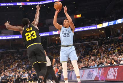 May 11, 2022; Memphis, Tennessee, USA; Memphis Grizzlies guard Desmond Bane (22) shoots the ball over Golden State Warriors forward Draymond Green (23) during game five of the second round for the 2022 NBA playoffs at FedExForum. Mandatory Credit: Joe Rondone-USA TODAY Sports