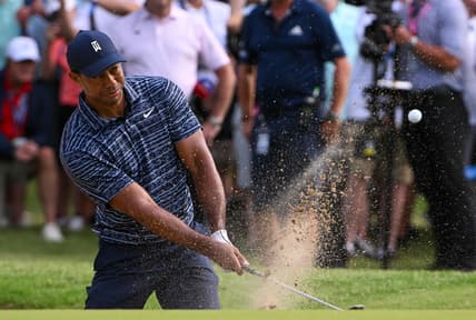 May 19, 2022; Tulsa, Oklahoma, USA; Tiger Woods plays his shot from the bunker on the 13th green during the first round of the PGA Championship golf tournament. Mandatory Credit: Orlando Ramirez-USA TODAY Sports