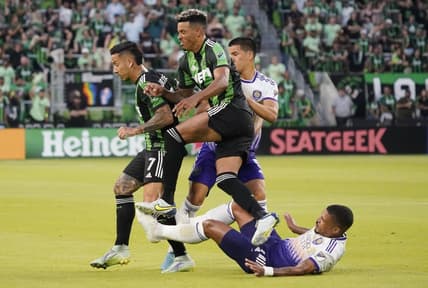 May 22, 2022; Austin, Texas, USA; Austin FC forward Sebastian Driussi (7) and defender Julio Cascante (18) get tangled up with Orlando City midfielder Junior Urso (11) and midfielder Cesar Araujo (5) during the second half at Q2 Stadium. Mandatory Credit: Scott Wachter-USA TODAY Sports