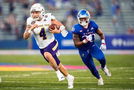 Sep 2, 2022; Lawrence, Kansas, USA; Tennessee Tech Golden Eagles quarterback Jeremiah Oatsvall (4) runs the ball past Kansas Jayhawks linebacker Rich Miller (30) during the first half at David Booth Kansas Memorial Stadium. Mandatory Credit: Jay Biggerstaff-USA TODAY Sports
