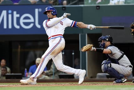 Oct 5, 2022; Arlington, Texas, USA; Texas Rangers right fielder Bubba Thompson (65) hits an rbi double during the fifth inning against the New York Yankees at Globe Life Field. Mandatory Credit: Kevin Jairaj-USA TODAY Sports