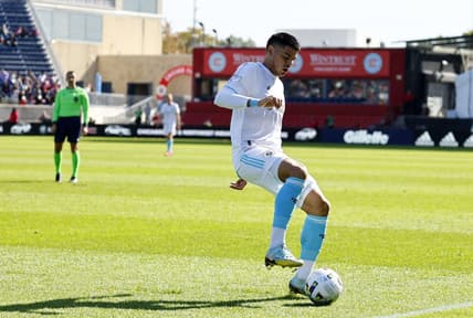 Oct 9, 2022; Chicago, Illinois, USA; New England Revolution forward Gustavo Bou (7) kicks the ball against the Chicago Fire during the first half at Bridgeview Stadium. Mandatory Credit: Mike Dinovo-USA TODAY Sports