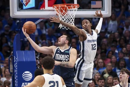 Oct 22, 2022; Dallas, Texas, USA; Dallas Mavericks guard Luka Doncic (77) shoots as Memphis Grizzlies guard Ja Morant (12) defends during the second half at American Airlines Center. Mandatory Credit: Kevin Jairaj-USA TODAY Sports