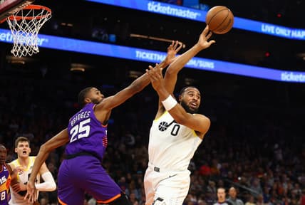 Nov 26, 2022; Phoenix, Arizona, USA; Utah Jazz guard Talen Horton-Tucker (0) passes the ball against Phoenix Suns forward Mikal Bridges (25) in the first half at Footprint Center. Mandatory Credit: Mark J. Rebilas-USA TODAY Sports