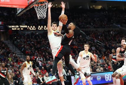 Jan 25, 2023; Portland, Oregon, USA;  Portland Trail Blazers guard Damian Lillard (0) shoots over Utah Jazz forward Jarred Vanderbilt (8) in the second half at Moda Center. Mandatory Credit: Jaime Valdez-USA TODAY Sports