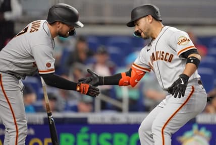 Apr 19, 2023; Miami, Florida, USA;  San Francisco Giants right fielder Michael Conforto (right) celebrates a two-run home run with first baseman J.D. Davis (7) in the se inning against the Miami Marlins at loanDepot Park. Mandatory Credit: Jim Rassol-USA TODAY Sports