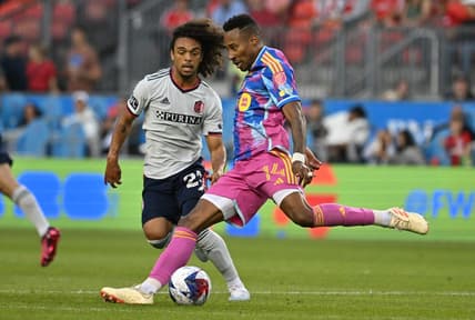 Jul 8, 2023; Toronto, Ontario, CAN;  Toronto FC midfielder Mark-Anthony Kaye (14) shoots the ball past St. Louis City midfielder Aziel Jackson (25) in the first half at BMO Field. Mandatory Credit: Dan Hamilton-USA TODAY Sports