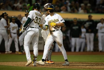 Jul 22, 2023; Oakland, California, USA; Oakland Athletics second baseman Zack Gelof (20) gets a congratulatory handshake from JJ Bleday (33) after hitting his first career home run during the seventh inning against the Houston Astros at Oakland-Alameda County Coliseum. Mandatory Credit: D. Ross Cameron-USA TODAY Sports