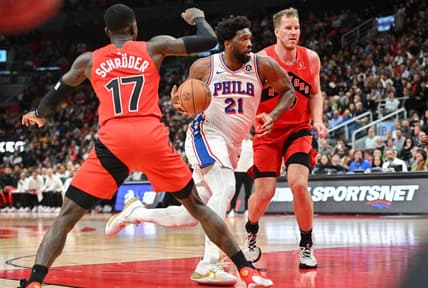 Oct 28, 2023; Toronto, Ontario, CAN;  Philadelphia 76ers center Joel Embiid (21) drives to the basket between Toronto Raptors center Jakob Poeltl (19) and guard Dennis Schroder (17) in the first half at Scotiabank Arena. Mandatory Credit: Dan Hamilton-USA TODAY Sports