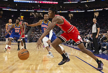 Nov 12, 2021; San Francisco, California, USA; Chicago Bulls guard Ayo Dosunmu (12) drives to the basket ahead of Golden State Warriors forward Andre Iguodala (9) during the second quarter at Chase Center. Mandatory Credit: D. Ross Cameron-USA TODAY Sports