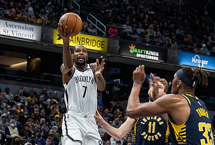 Jan 5, 2022; Indianapolis, Indiana, USA; Brooklyn Nets forward Kevin Durant (7) shoots the ball while Indiana Pacers forward Domantas Sabonis (11) and center Myles Turner (33) defend in the second half at Gainbridge Fieldhouse. Mandatory Credit: Trevor Ruszkowski-USA TODAY Sports