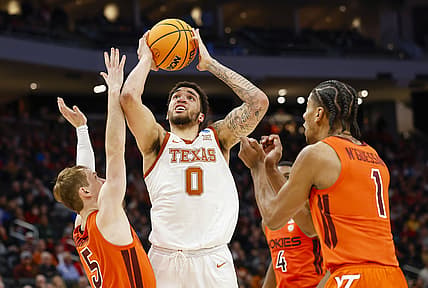 Mar 18, 2022; Milwaukee, WI, USA; Texas Longhorns forward Timmy Allen (0) shoots against Virginia Tech Hokies guard Storm Murphy (5) during the first half in the first round of the 2022 NCAA Tournament at Fiserv Forum. Mandatory Credit: Jeff Hanisch-USA TODAY Sports