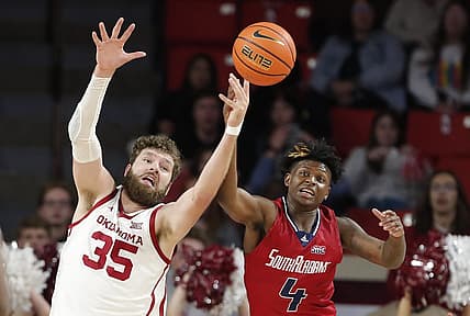Nov 18, 2022; Norman, Oklahoma, USA; Oklahoma Sooners forward Tanner Groves (35) and South Alabama Jaguars guard Isaiah Moore (4) reach for a loose ball during the first half at Lloyd Noble Center. Mandatory Credit: Alonzo Adams-USA TODAY Sports