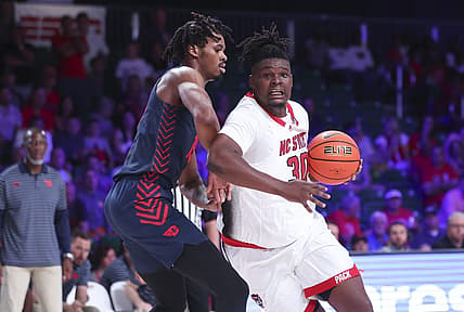 Nov 24, 2022; Paradise Island, BAHAMAS; North Carolina State Wolfpack forward D.J. Burns Jr. (30) drives to the basket as Dayton Flyers forward DaRon Holmes II (15) defends during the first half at Imperial Arena. Mandatory Credit: Kevin Jairaj-USA TODAY Sports