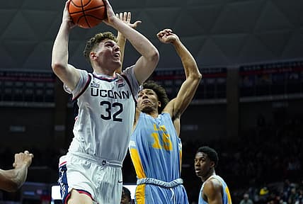 Dec 10, 2022; Storrs, Connecticut, USA; UConn Huskies center Donovan Clingan (32) shoots against Long Island Sharks forward/center C.J. Delancy (15) in the first half at Harry A. Gampel Pavilion. Mandatory Credit: David Butler II-USA TODAY Sports