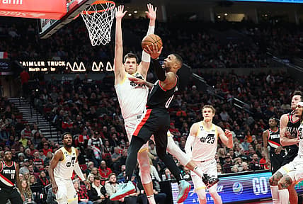 Jan 25, 2023; Portland, Oregon, USA;  Portland Trail Blazers guard Damian Lillard (0) shoots over Utah Jazz forward Jarred Vanderbilt (8) in the second half at Moda Center. Mandatory Credit: Jaime Valdez-USA TODAY Sports