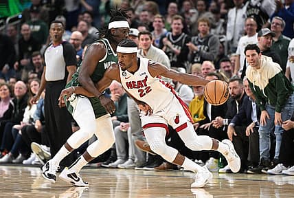 Apr 26, 2023; Milwaukee, Wisconsin, USA; Miami Heat forward Jimmy Butler (22) drives against Milwaukee Bucks guard Jrue Holiday (21) during game five of the 2023 NBA Playoffs at Fiserv Forum. Mandatory Credit: Michael McLoone-USA TODAY Sports