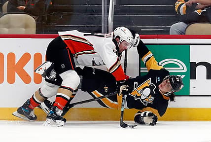 Oct 30, 2023; Pittsburgh, Pennsylvania, USA;  Anaheim Ducks left wing Ross Johnston (44) checks Pittsburgh Penguins defenseman Ryan Graves (27) during the third period at PPG Paints Arena. Mandatory Credit: Charles LeClaire-USA TODAY Sports
