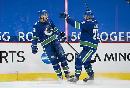 Jan 25, 2021; Vancouver, British Columbia, CAN; Vancouver Canucks forward Brandon Sutter (20) and  defenseman Alexander Edler (23) celebrate Sutter s third goal of the game against the Ottawa Senators in the third period at Rogers Arena. Vancouver won 7-1.  Mandatory Credit: Bob Frid-USA TODAY Sports