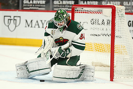 Mar 5, 2021; Glendale, Arizona, USA; Minnesota Wild goaltender Kaapo Kahkonen (34) blocks a shot against the Arizona Coyotes during the second period at Gila River Arena. Mandatory Credit: Mark J. Rebilas-USA TODAY Sports