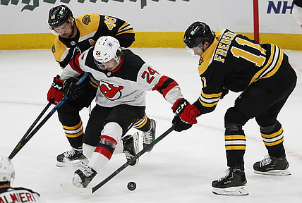 Mar 7, 2021; Boston, Massachusetts, USA; New Jersey Devils defenseman Ty Smith (24) tries to hold off Boston Bruins center Trent Frederic (11) and center David Krejci (46) during the first period at TD Garden. Mandatory Credit: Winslow Townson-USA TODAY Sports