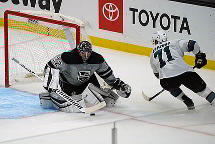 Apr 3, 2021; Los Angeles, California, USA; Los Angeles Kings goaltender Jonathan Quick (32) blocks a shot against San Jose Sharks defenseman Nikolai Knyzhov (71) during the third period at Staples Center. Mandatory Credit: Gary A. Vasquez-USA TODAY Sports