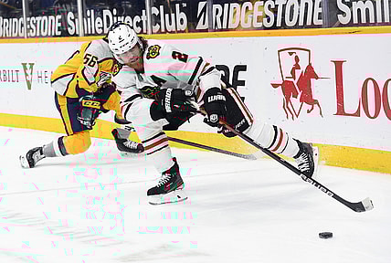 Apr 19, 2021; Nashville, Tennessee, USA; Chicago Blackhawks defenseman Duncan Keith (2) plays the puck after taking it from Nashville Predators left wing Erik Haula (56) during the first period at Bridgestone Arena. Mandatory Credit: Christopher Hanewinckel-USA TODAY Sports