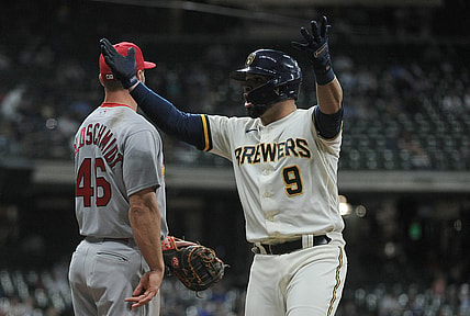 May 12, 2021; Milwaukee, Wisconsin, USA;  Milwaukee Brewers catcher Manny Pina (9) reacts to the Milwaukee Brewers bench after getting a hit against the St. Louis Cardinals in the fifth inning at American Family Field. Mandatory Credit: Michael McLoone-USA TODAY Sports