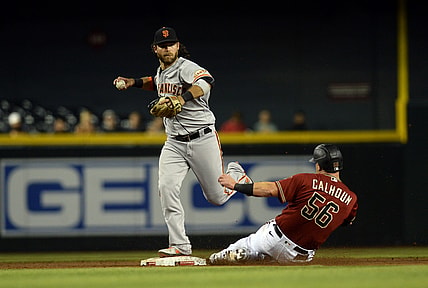 Aug 4, 2021; Phoenix, Arizona, USA; San Francisco Giants shortstop Brandon Crawford (top) forces out Arizona Diamondbacks right fielder Kole Calhoun (56) at second base during the sixth inning at Chase Field. Mandatory Credit: Joe Camporeale-USA TODAY Sports