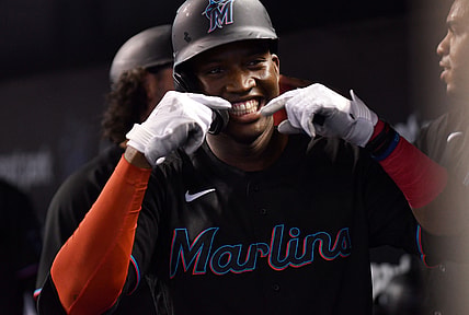 Aug 28, 2021; Miami, Florida, USA; Miami Marlins outfielder Jesus Sanchez (76) celebrates with teammates after hitting a three run home run against the Cincinnati Reds during the first inning at loanDepot Park. Mandatory Credit: Jim Rassol-USA TODAY Sports