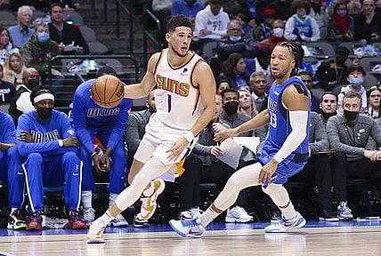 Jan 20, 2022; Dallas, Texas, USA;  Phoenix Suns guard Devin Booker (1) drives to the basket past Dallas Mavericks guard Jalen Brunson (13) during the first half at American Airlines Center. Mandatory Credit: Kevin Jairaj-USA TODAY Sports