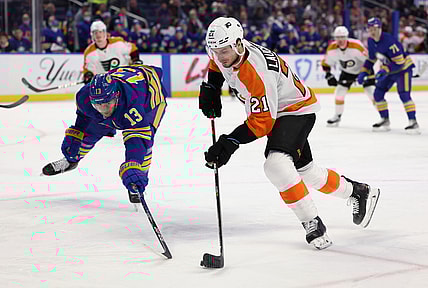 Jan 22, 2022; Buffalo, New York, USA;  Buffalo Sabres defenseman Mark Pysyk (13) tries to block a shot by Philadelphia Flyers center Scott Laughton (21) during the first period at KeyBank Center. Mandatory Credit: Timothy T. Ludwig-USA TODAY Sports