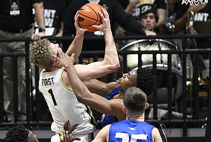 Dec 7, 2022; West Lafayette, Indiana, USA; Hofstra Pride forward Warren Williams (0) gets his hand on the face of Purdue Boilermakers forward Caleb Furst (1) during the first half at Mackey Arena. Mandatory Credit: Marc Lebryk-USA TODAY Sports