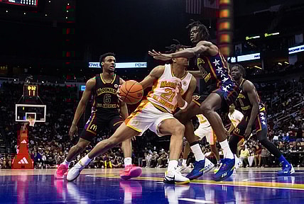 Mar 28, 2023; Houston, TX, USA; East guard DJ Wagner (center) drives to the basket against West forward Baye Fall during the McDonald's All American Boy's high school basketball game at Toyota Center. Mandatory Credit: Mark J. Rebilas-USA TODAY Sports