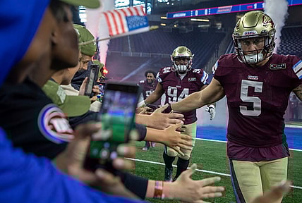 Fans greet Michigan Panthers Jamal Milan (94), Frank Ginda (5) and their teammates as they walk into the field before the start of their game against the Birmingham Stallions at Ford Field in Detroit on Saturday, May 20, 2023.