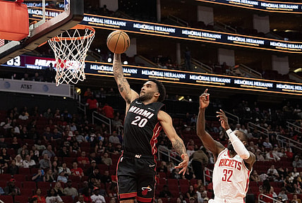Oct 20, 2023; Houston, Texas, USA; Miami Heat forward Justin Champagnie (20) dunks as Houston Rockets forward Jeff Green (32) defends in the fourth quarter at Toyota Center. Mandatory Credit: Thomas Shea-USA TODAY Sports