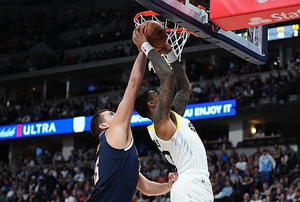 Oct 30, 2023; Denver, Colorado, USA; Denver Nuggets center Nikola Jokic (15) blocks the shot of Utah Jazz forward John Collins (20) in the second quarter at Ball Arena. Mandatory Credit: Ron Chenoy-USA TODAY Sports