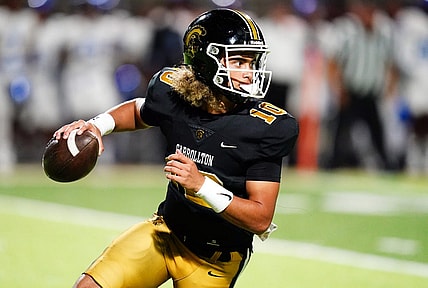 Oct 20, 2023; Carrollton, GA, USA; Carrollton Trojans quarterback Julian Lewis (10) scrambles out of the pocket against the Westlake Lions during the first half at Grisham Stadium. The 15-year-old Carrollton High student has already committed to playing for the University of Southern California Trojans and has been considered one of the top high school quarterback prospects. Mandatory Credit: John David Mercer-USA TODAY Sports