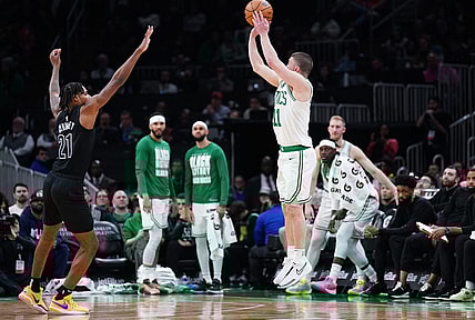 Feb 14, 2024; Boston, Massachusetts, USA; Boston Celtics guard Payton Pritchard (11) shoots for three points against Brooklyn Nets forward Noah Clowney (21) in the second half at TD Garden. Mandatory Credit: David Butler II-USA TODAY Sports