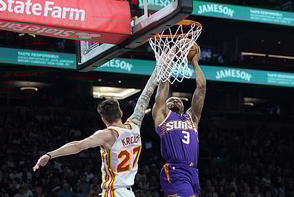 Mar 21, 2024; Phoenix, Arizona, USA; Phoenix Suns guard Bradley Beal (3) dunks over Atlanta Hawks guard Vit Krejci (27) during the first half at Footprint Center. Mandatory Credit: Joe Camporeale-USA TODAY Sports