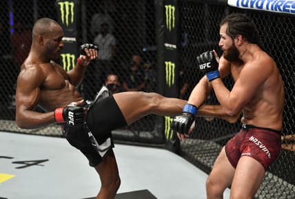 July 12, 2020; Abu Dhabi, UAE;  Kamaru Usman of Nigeria kicks Jorge Masvidal in their UFC welterweight championship fight during the UFC 251 event at Flash Forum on UFC Fight Island on July 12, 2020 on Yas Island, Abu Dhabi, United Arab Emirates.  Mandatory Credit: Jeff Bottari/Zuffa LLC via USA TODAY Sports