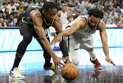Apr 9, 2022; San Antonio, Texas, USA; Golden State Warriors forward Jonathan Kuminga (left) and San Antonio Spurs forward Keita Bates-Diop (right) battle for a loose ball during the first half at AT&T Center. Mandatory Credit: Scott Wachter-USA TODAY Sports