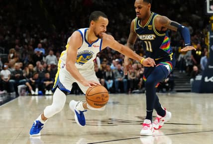 Apr 24, 2022; Denver, Colorado, USA; Golden State Warriors guard Stephen Curry (30) drives at Denver Nuggets guard Monte Morris (11) in the second half of the first round for the 2022 NBA playoffs at Ball Arena. Mandatory Credit: Ron Chenoy-USA TODAY Sports