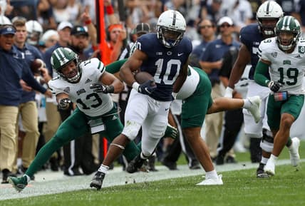 Sep 10, 2022; University Park, Pennsylvania, USA; Penn State Nittany Lions running back Nicholas Singleton (10) avoids a tackle while running with the ball during the first quarter against the Ohio Bobcats at Beaver Stadium. Mandatory Credit: Matthew OHaren-USA TODAY Sports